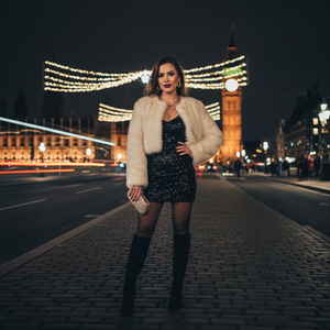 make the woman wear more of like a girly outfit that she is going on a night out and make the background darker 